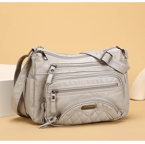 Detail of multi-pocket soft washed PU leather crossbody bag with quilted stitching