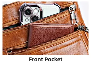 Detailed view of the front pocket on a brown leather shoulder bag with a phone and wallet