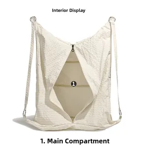 Detail view of the spacious inner compartment and zipper of the quilted nylon tote bag