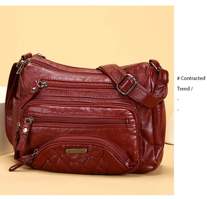 Macro detail of dark red soft washed leather with diamond quilting and zipper pockets