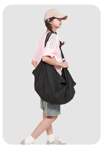 Side view of large plaid hobo bag with water-resistant fabric and wide shoulder strap