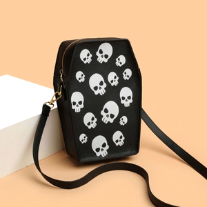 Gothic coffin-shaped crossbody bag with white skull prints and adjustable strap