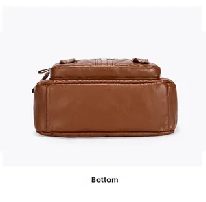 Detailed bottom view of large capacity brown leather shoulder bag showing neat stitching