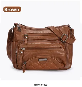 Detailed front view of soft brown faux leather shoulder bag with multiple zippers