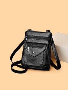 Crossbody cell phone bag in black faux leather with multiple zipper pockets and lychee texture