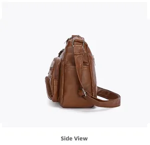 Side view of brown soft leather shoulder bag with multiple zipper compartments