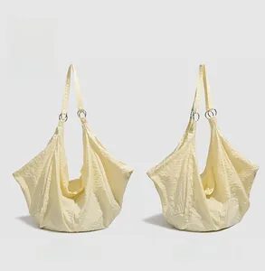 Detailed front and side view of yellow waterproof quilted crossbody dumpling bag