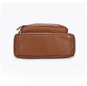 Detailed bottom view of brown soft leather shoulder bag showing stitching and flat base