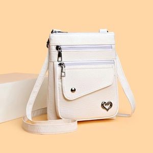 Minimalist beige crossbody phone bag for women with multi-zipper and metal heart detail