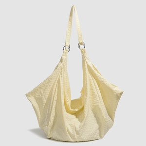 Waterproof light yellow hobo bag with quilted waffle texture and metallic rings