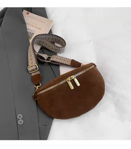 Brown suede half-moon chest bag with ethnic woven strap and golden zipper details