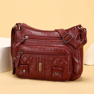 Deep red soft leather crossbody bag with multi-pocket design and quilted details