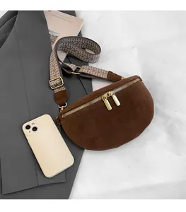 Detailed view of brown faux suede moon bag with bohemian strap and size comparison