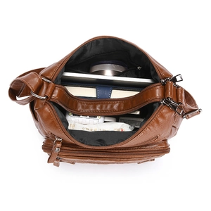 Brown vintage faux leather crossbody bag showing three large zip compartments with storage