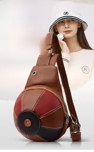 Detailed view of basketball shaped crossbody bag with lychee pattern leather and metal zippers