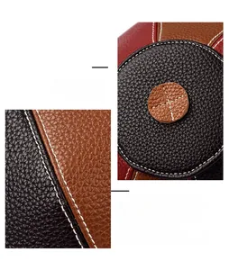Detail of color-block pebbled leather bag showing white reinforced stitching and texture
