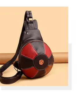 Close-up of vintage leather chest bag featuring stitched multi-color ball pattern