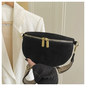 Detail of black suede crescent chest bag featuring dual zippers and vintage jacquard strap