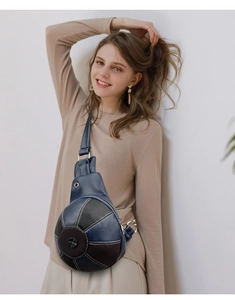 Detail of football-shaped crossbody bag with blue lychee leather and white stitching