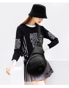 Detail showing creative black basketball shaped chest bag with premium pebble leather texture