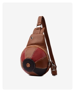 Detail of creative basketball-shaped crossbody bag with premium pebbled leather texture