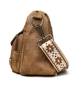 Detail view of the vintage brown crossbody bag featuring jacquard geometric shoulder strap