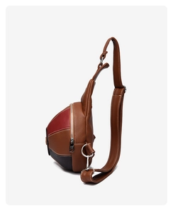 Detail view of tri-color patchwork chest bag featuring premium lychee texture leather