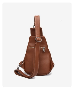 Detail of brown litchi pattern leather chest bag with back zipper and silver hardware