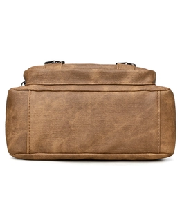 Detail of vintage brown soft leather bag showing crosshatch texture and precise stitching