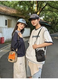 Outdoor lifestyle shot of drawstring crossbody bucket bags with adjustable straps