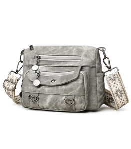 Detail of grey vintage canvas crossbody bag with multi-zipper and ethnic strap