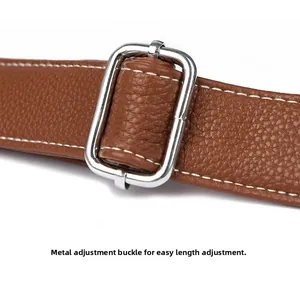 Detail of adjustable silver buckle and brown litchi leather strap with white stitching