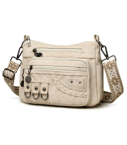 Detail of off-white multi-pocket crossbody bag with ethnic embroidered wide strap