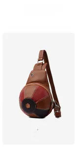 Detail view of yellowish brown leather bag featuring ball shape and pebble grain texture