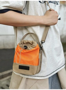 Detail of color-block crossbody water bottle bag with drawstring and adjustable strap