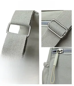 Detail of adjustable metal buckle, grey fabric texture, and zipper on crossbody bag