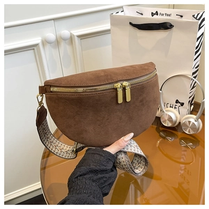 Detail of brown suede crossbody chest bag featuring a textured ethnic wide strap