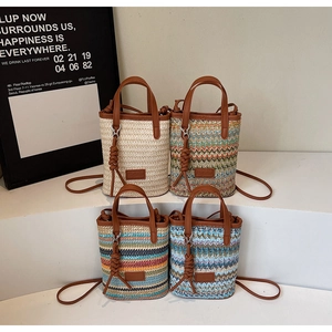 Collage of four mini straw bucket bags with leather straps in various striped patterns