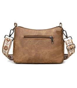 Brown soft leather crossbody bag featuring patterned jacquard strap and front zip pocket