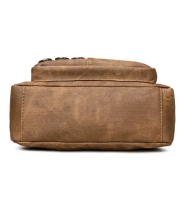 Detailed bottom view of brown soft leather shoulder bag with metallic decorative rings
