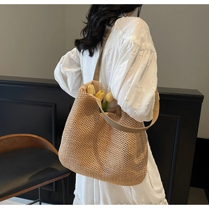 Detail of hand-woven straw tote bag showing hollow grid pattern and summer vibe style