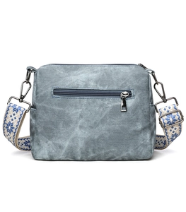 Detailed back view of navy vintage soft leather crossbody bag with zipper pocket and wide strap