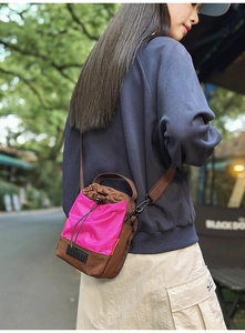 Outdoor model wearing a contrast nylon drawstring bag for phone and water bottle