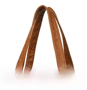 Detail of caramel brown leather shoulder straps with premium lychee grain texture
