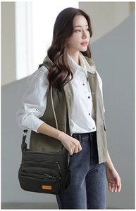 Practical multi-pocket black nylon crossbody bag with side compartments and zipper detail