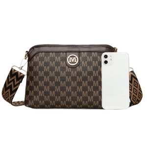 Vintage brown monogram crossbody bag with golden M logo and wide woven strap on white background