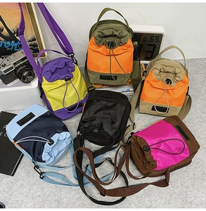 Detailed view of color-block nylon crossbody bags in various vibrant tactical shades
