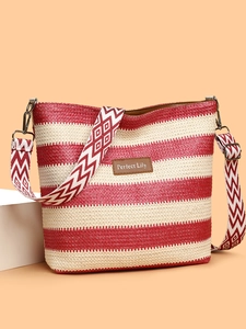 Detail of red and white striped woven tote bag with a patterned wide shoulder strap