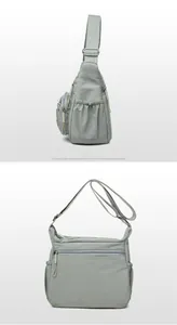 Detail view of light sage green crossbody bag with functional side drawstrings and pockets