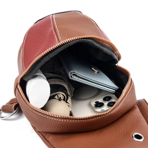 Fashionable patchwork leather sling bag showing internal storage for phone and wallet